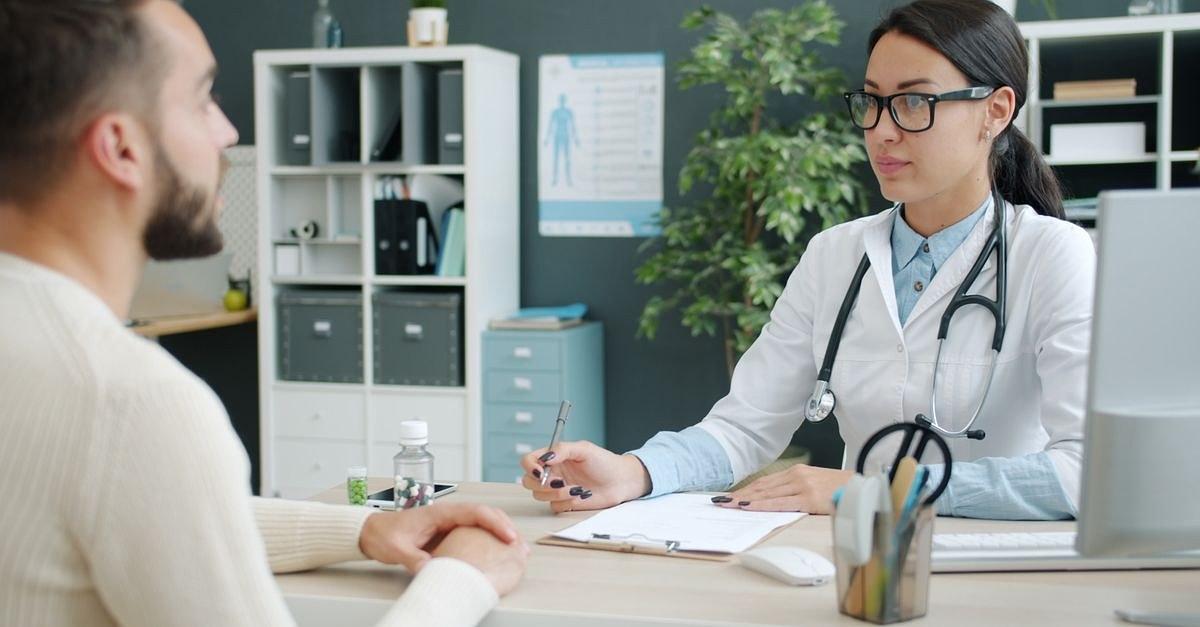A doctor and patient engaged in consultation in a modern clinic office.