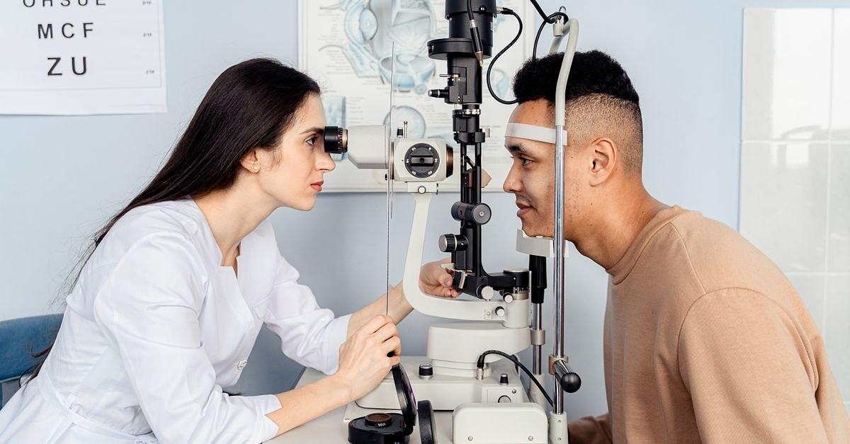 Professional eye examination conducted by an optometrist using modern equipment with a patient.