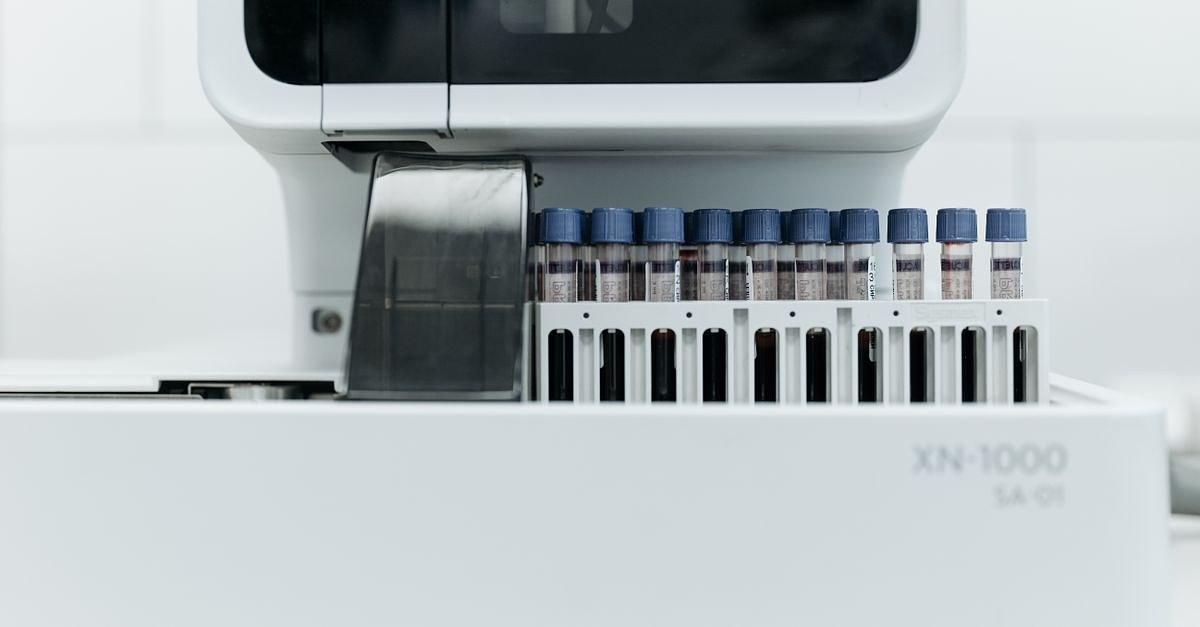 Close-up of laboratory machine holding test tubes for analysis.