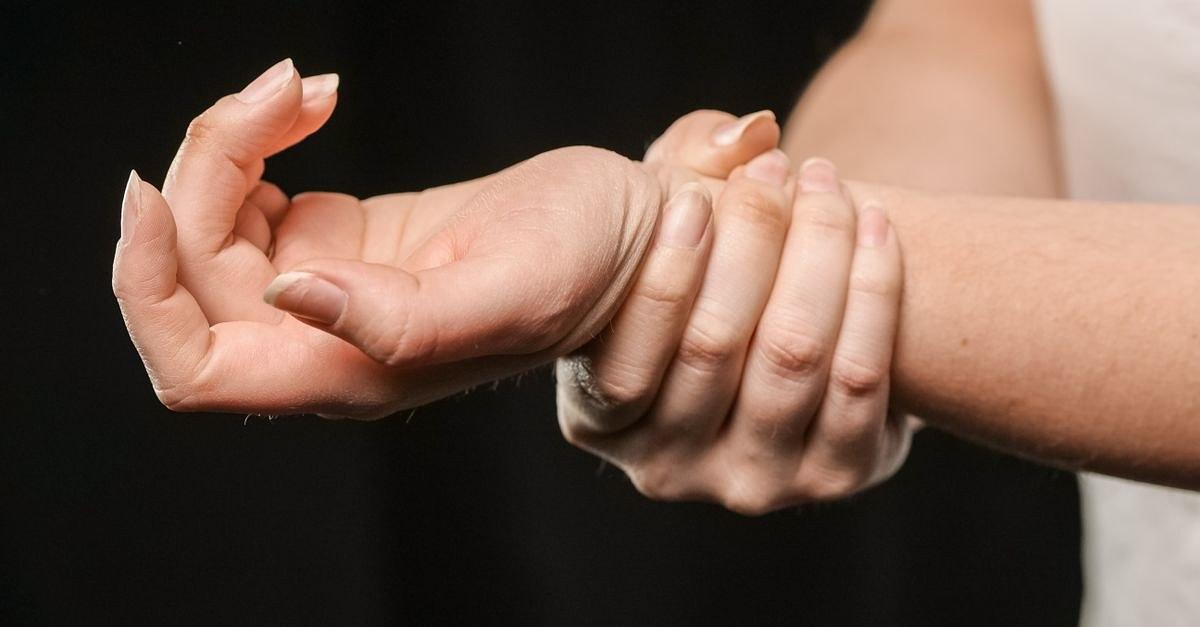 A close-up image of hands grasping a wrist, showcasing human connection and support.
